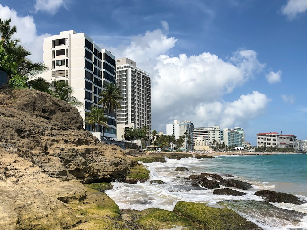 white and black concrete buildings under blue sky at daytime