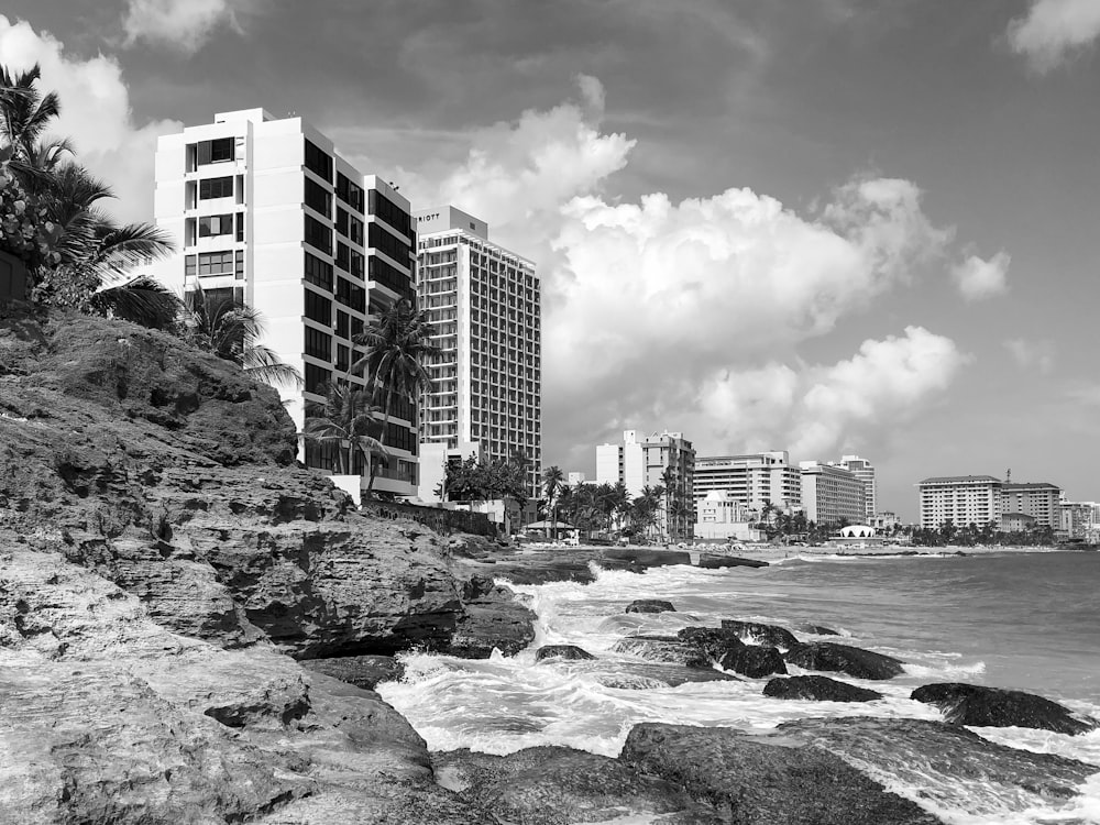 grayscale photography of rocks on sea