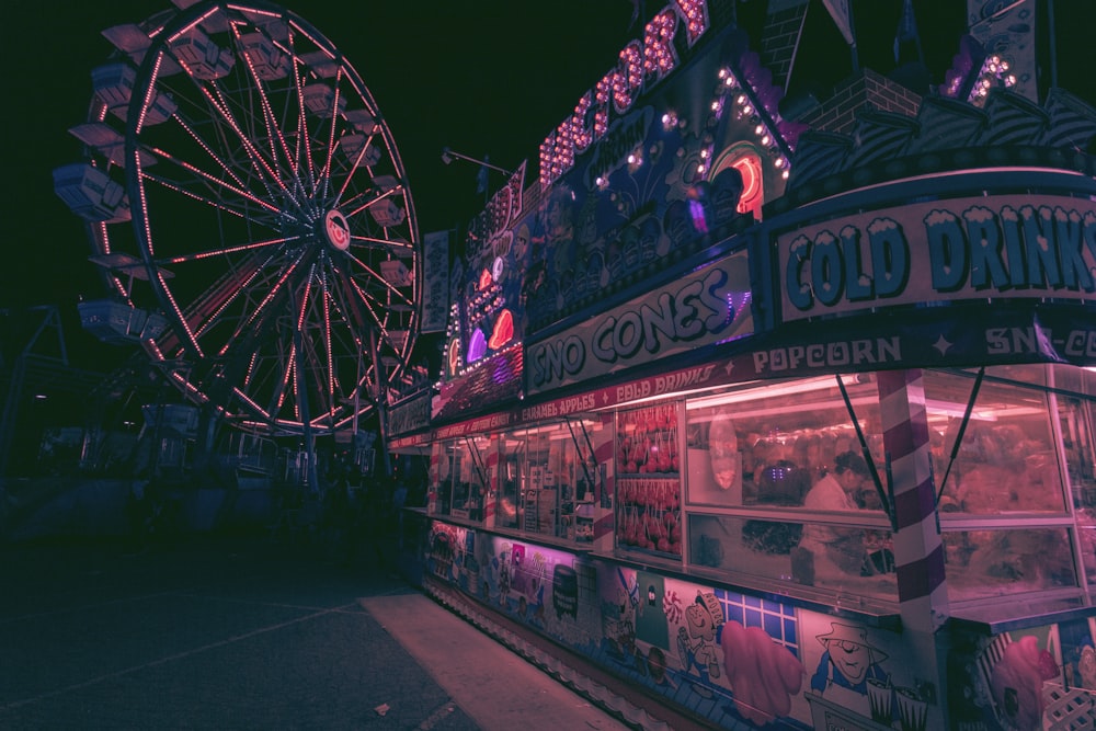 a carnival with a ferris wheel in the background