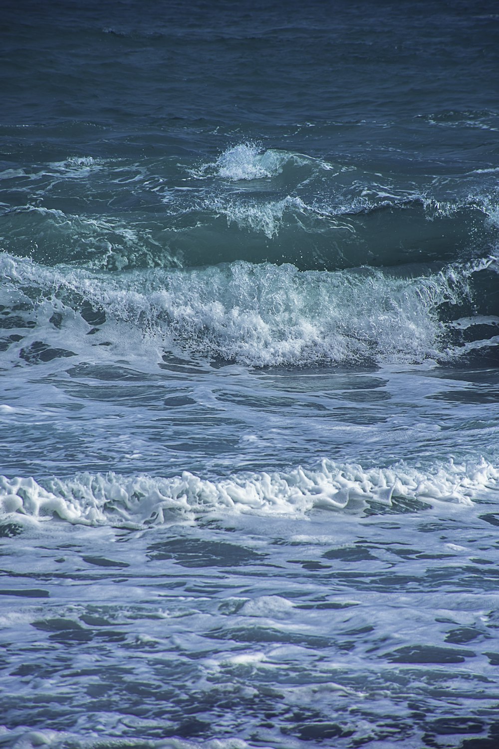 a person standing on a surfboard in the ocean