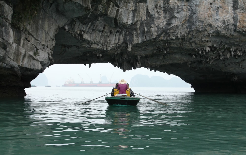 person riding on green boat during daytime