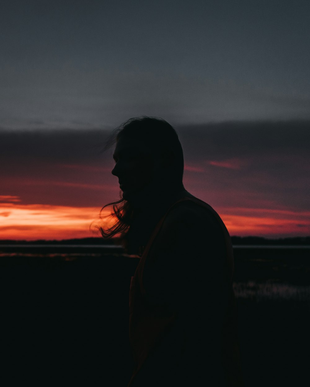 silhouette of woman near mountain