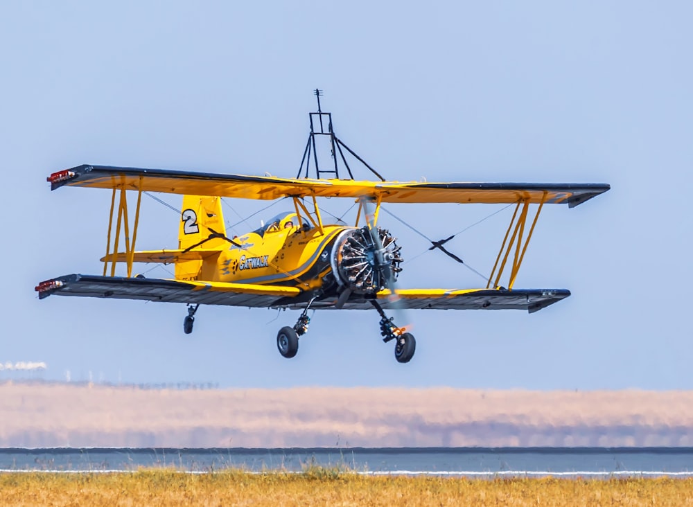 yellow and black biplane