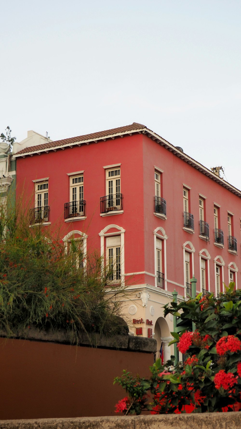 a red building with white windows and balconies