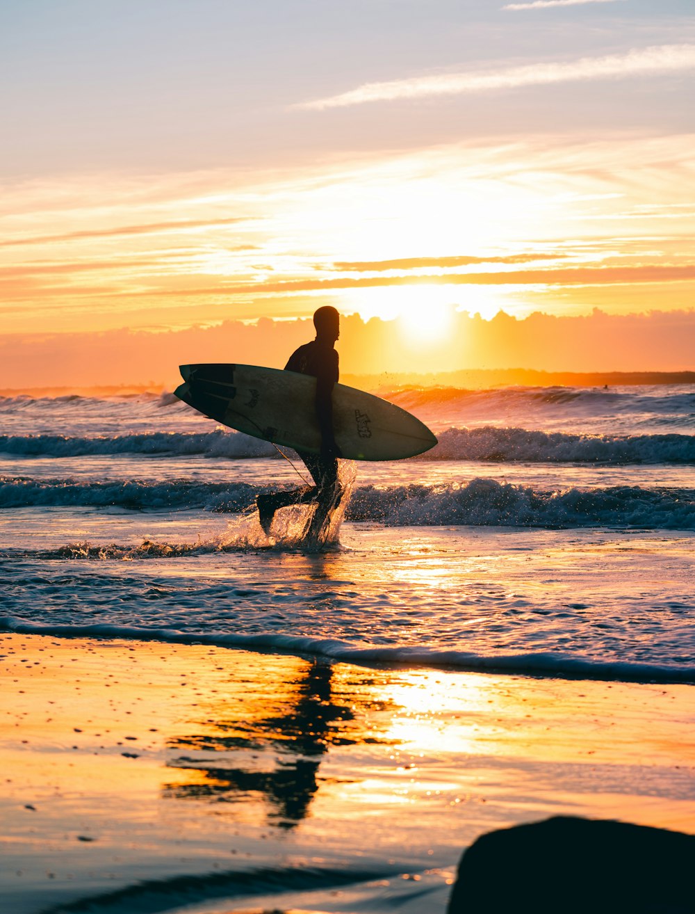man holding surfboard during daytime