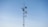 A tall communication tower is equipped with multiple satellite dishes and antennas against a clear blue sky.