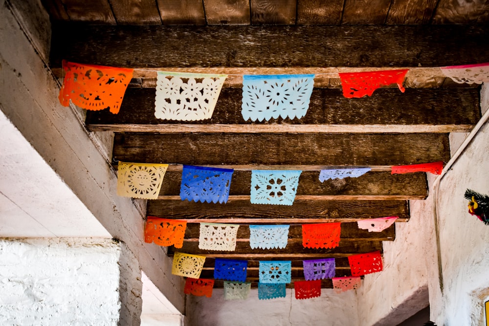 a group of colorful paper doily hanging from a ceiling