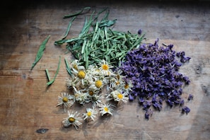Freshly picked flowers and dried blooms arranged on a wooden table