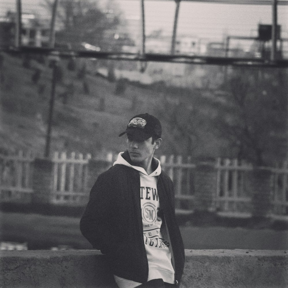 a young man is sitting on a ledge