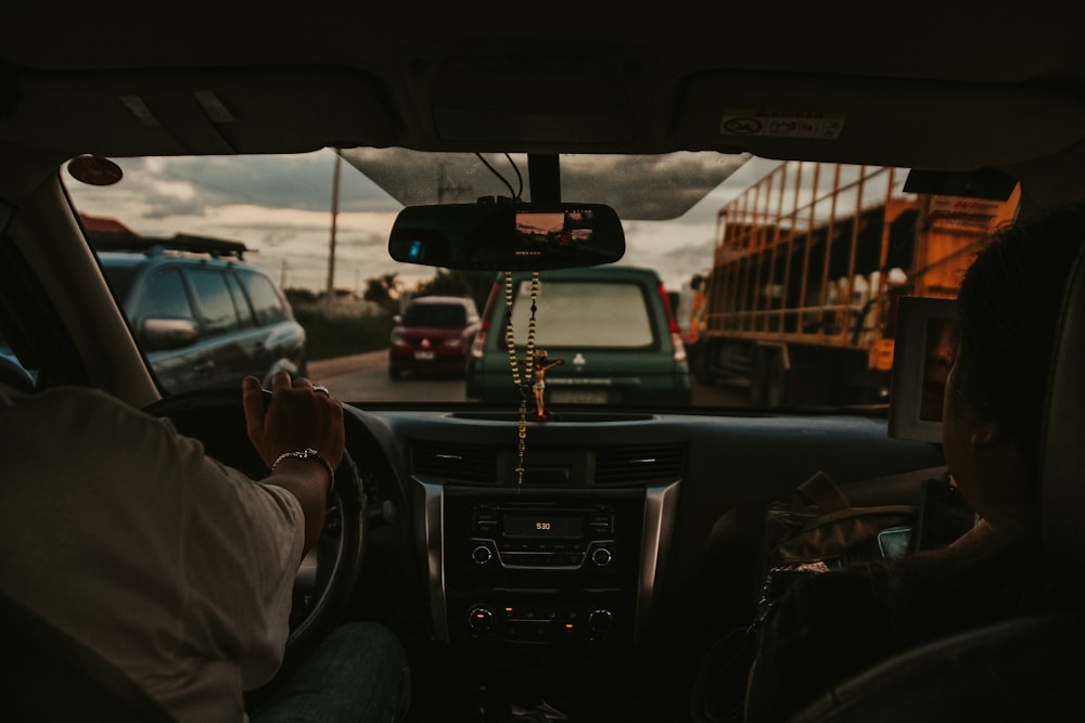 a man driving a car down a street