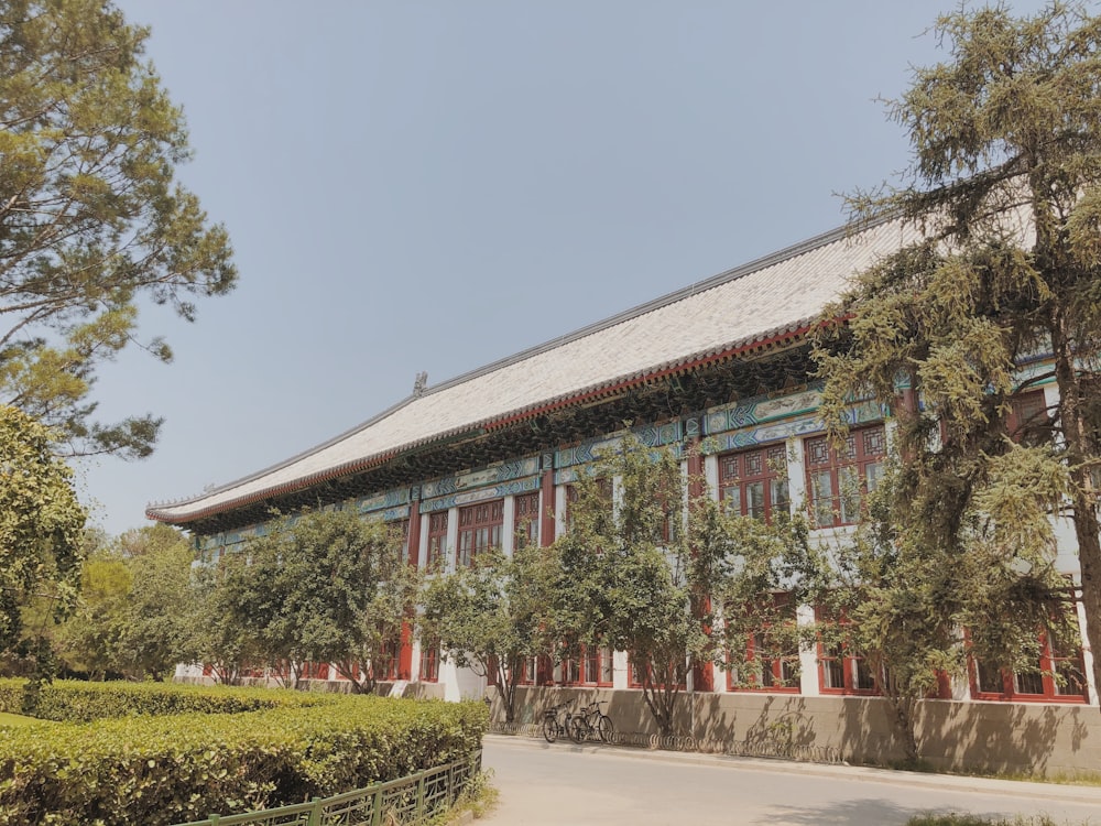 green trees surrounding brown multi-story building