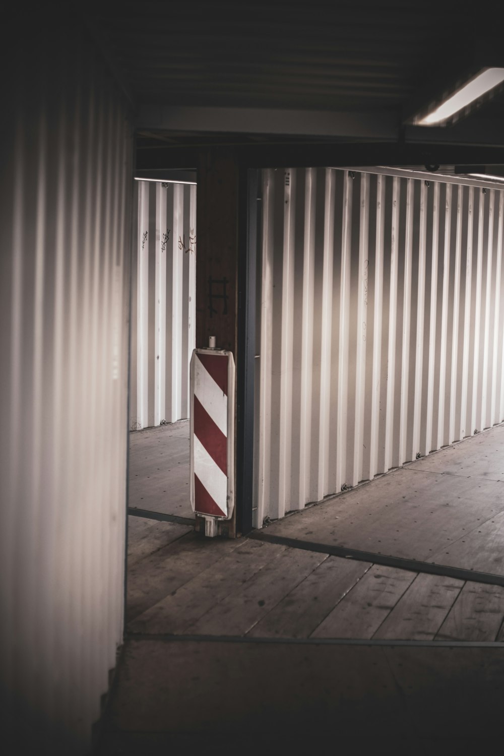 a red and white striped barricade in a building
