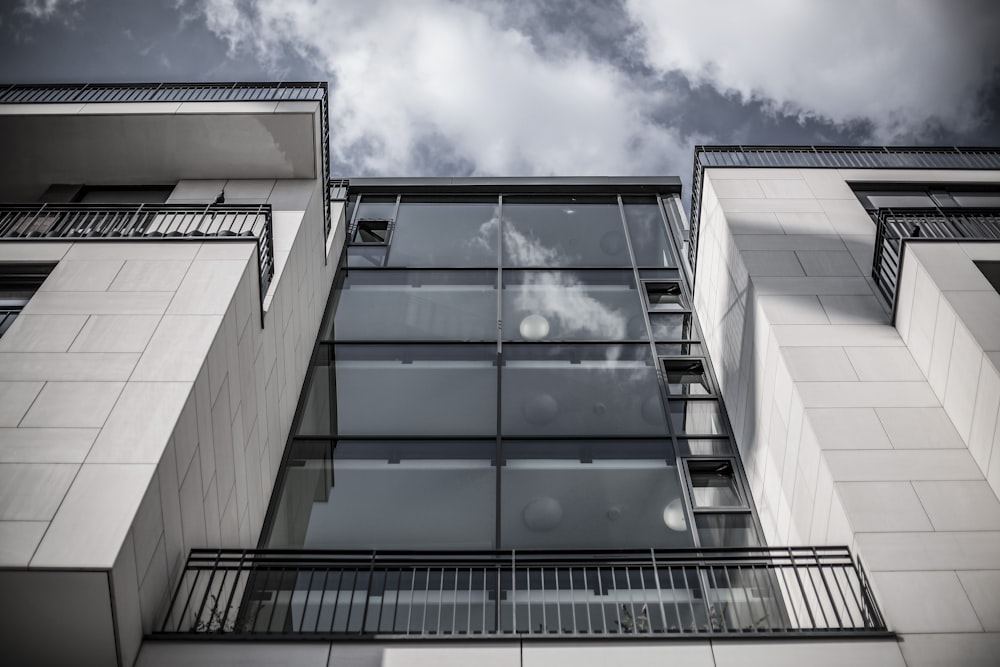 low angle photography of white concrete and clear glass building