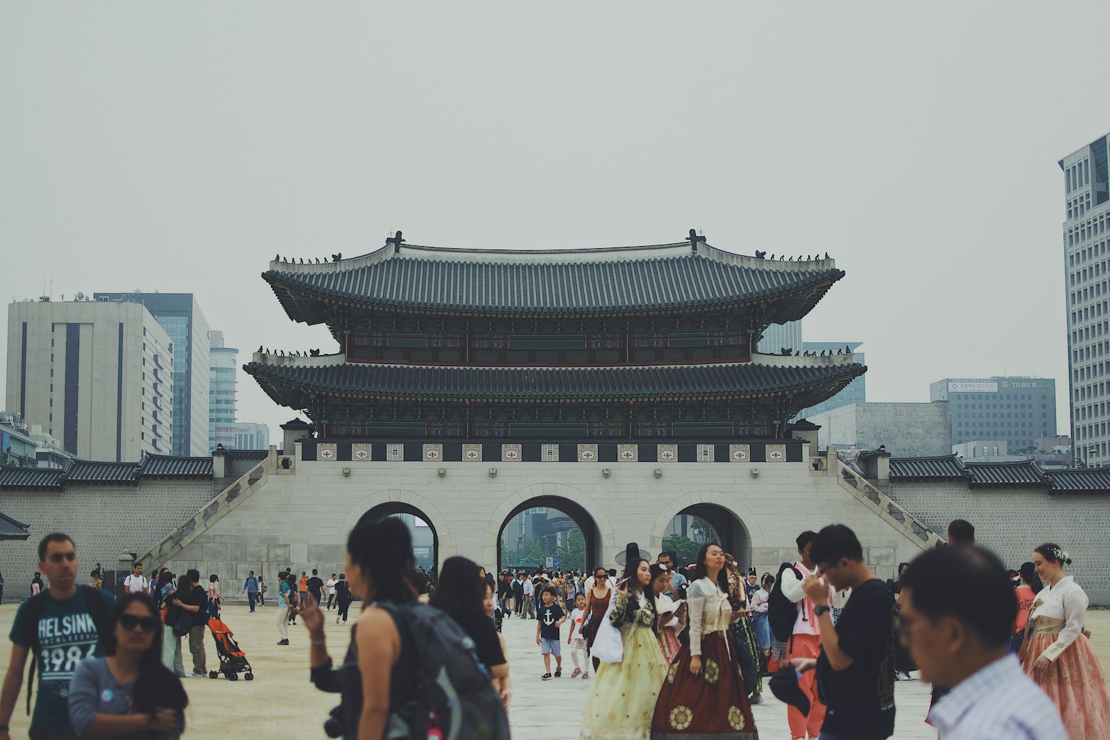 people standing across Gyeongbokgung Palace in Seoul, South Korea