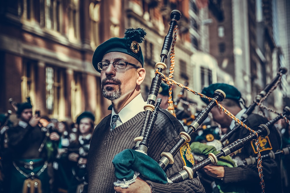 close-up photography of man carrying instrument