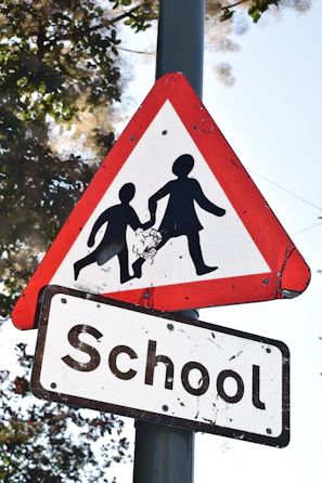 An informative banner highlighting signs of online predators displayed at a school.