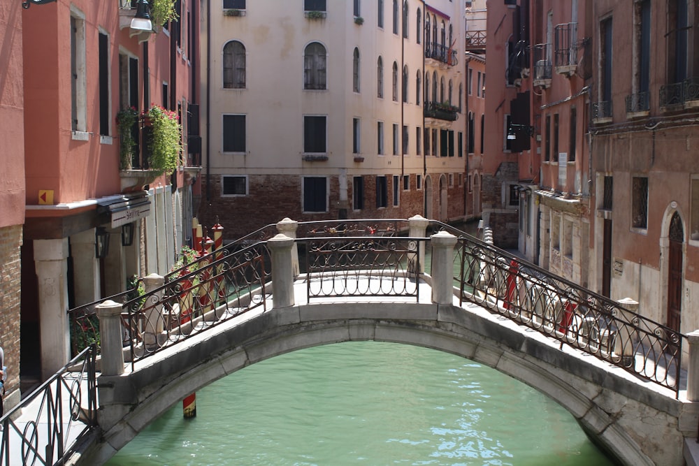 a bridge over a small canal in a city