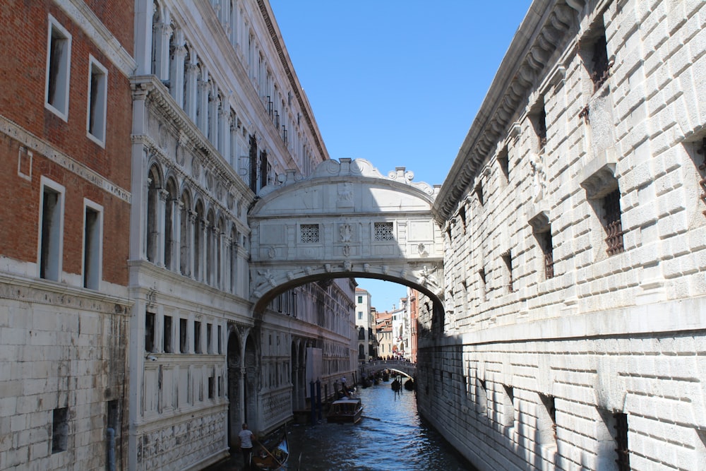 canal between white concrete buildings