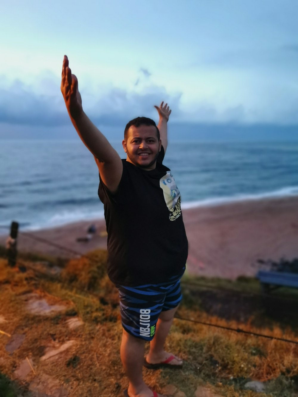 man standing beside sea during daytime