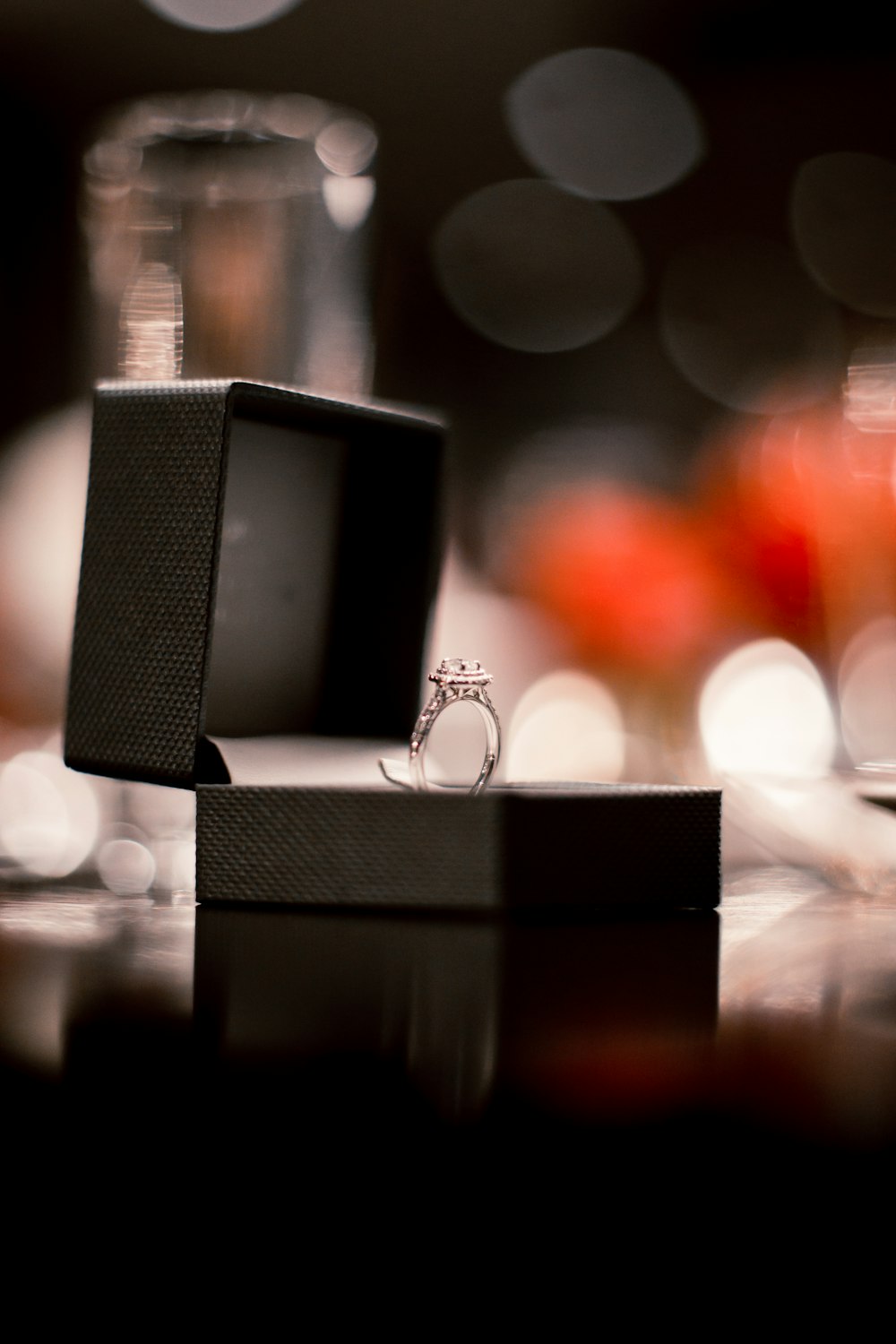 silver ring with diamond solitaire in a black box