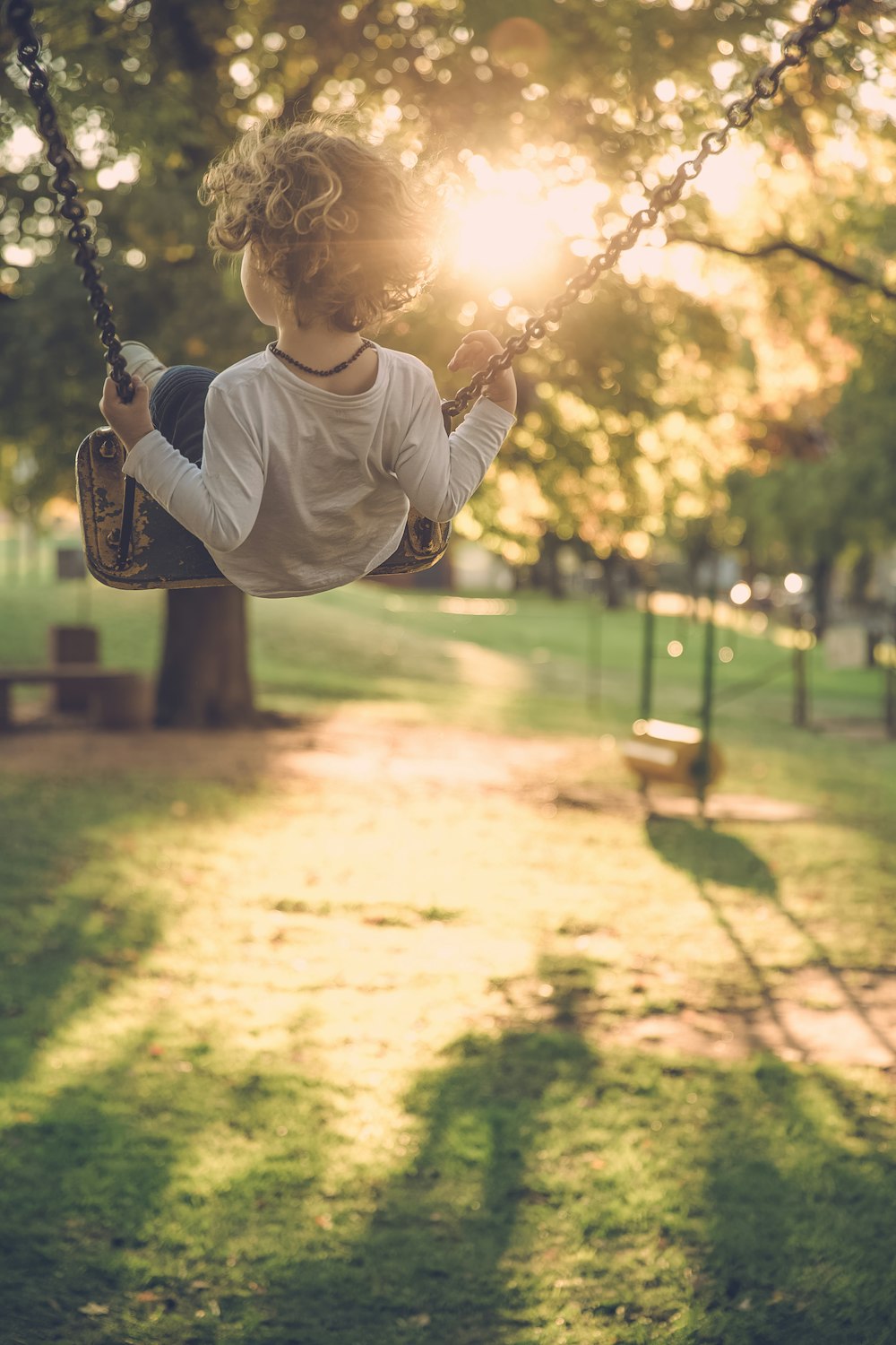 boy sitting on the swing