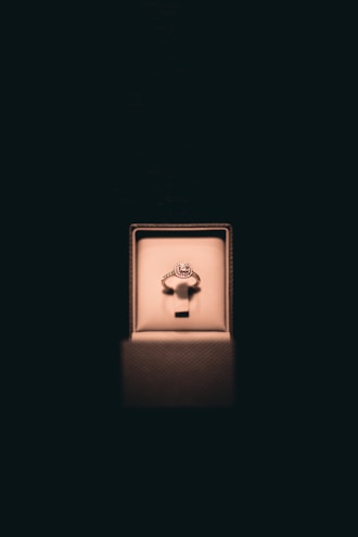 Elegant Atalaia rings displayed on a matte black background with soft lighting.