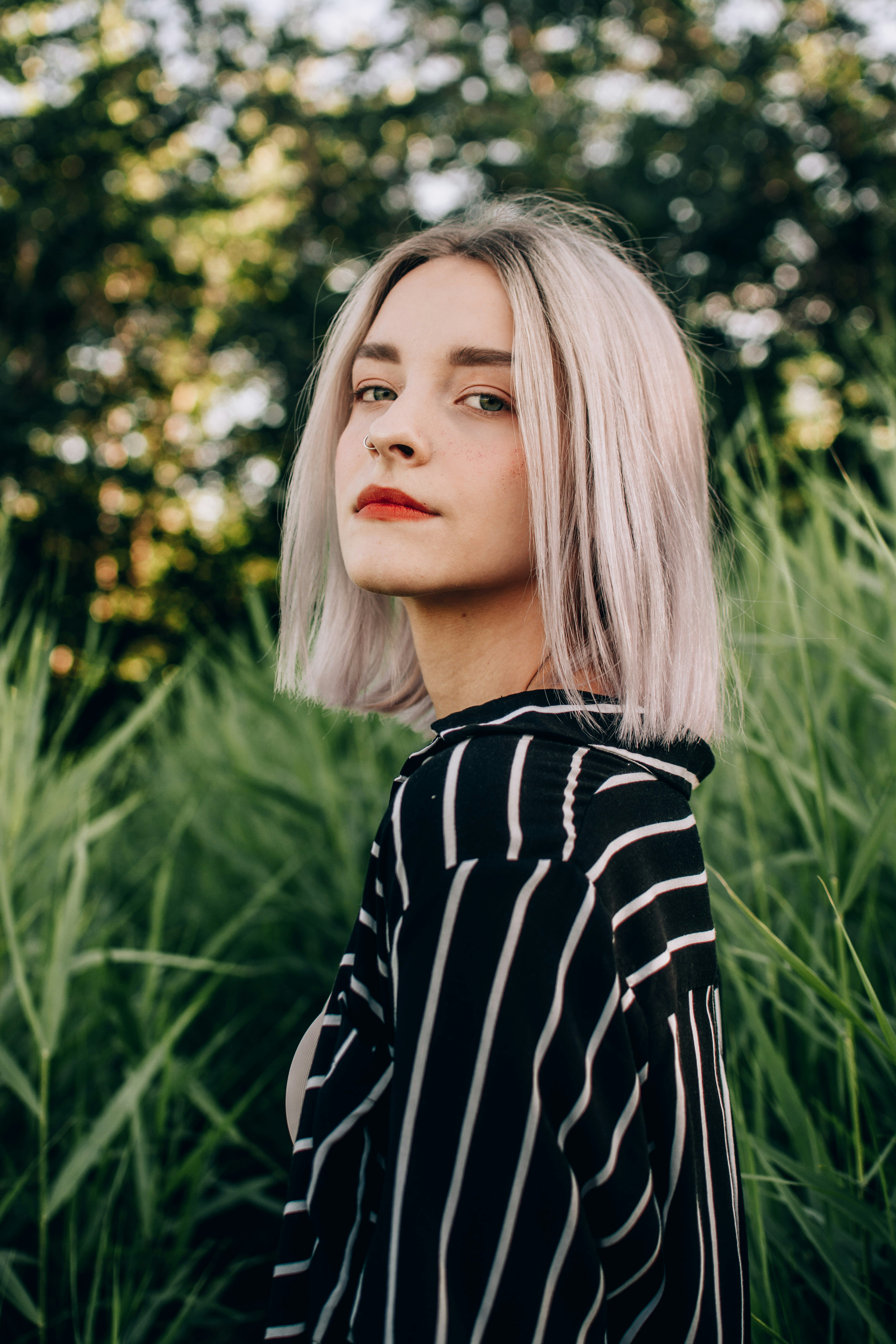 woman in white and black pinstriped shirt