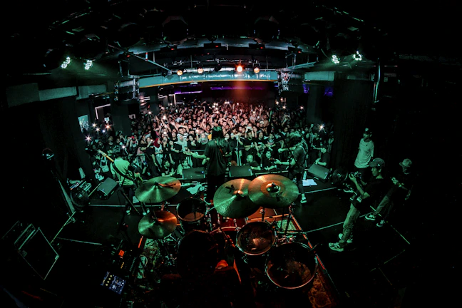 Vibrant stage with a band performing live, capturing the energy of the event.