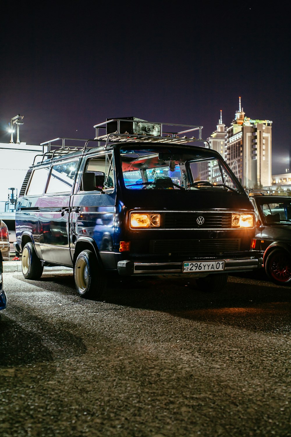 van parked beside vehicles during night