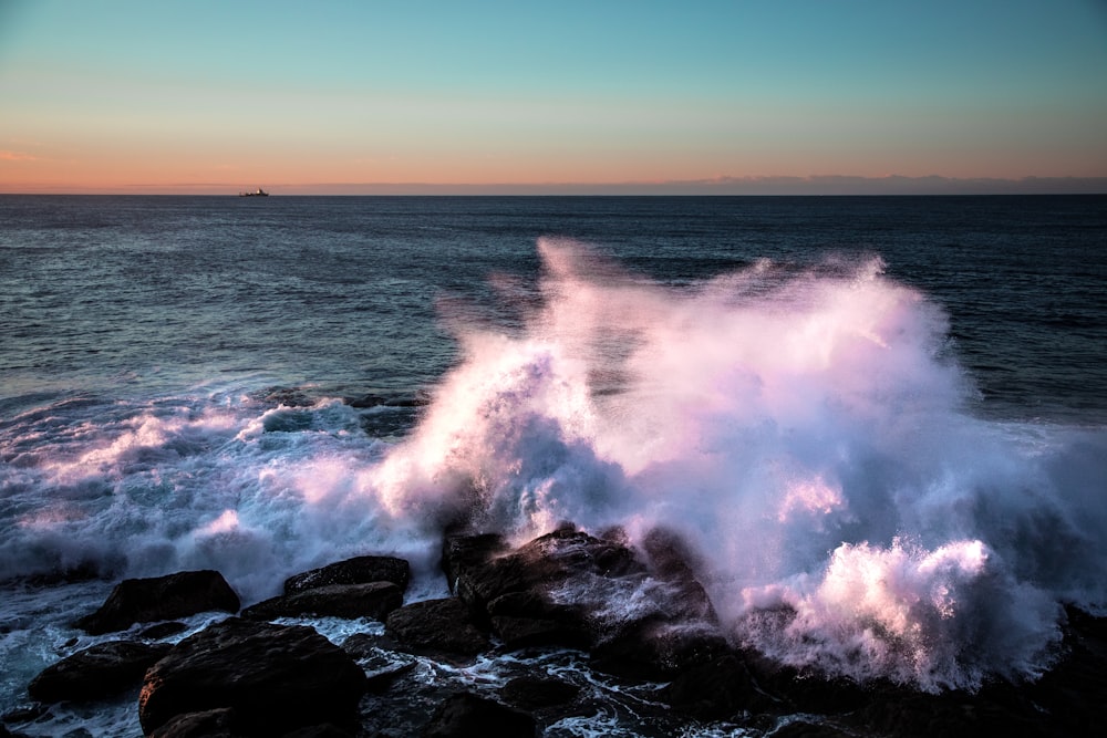 sea water hitting rocks