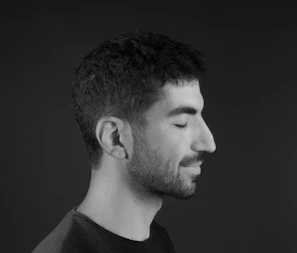 Portrait of a man with expressive eyes and a calm demeanor, vertical 4:6 aspect ratio