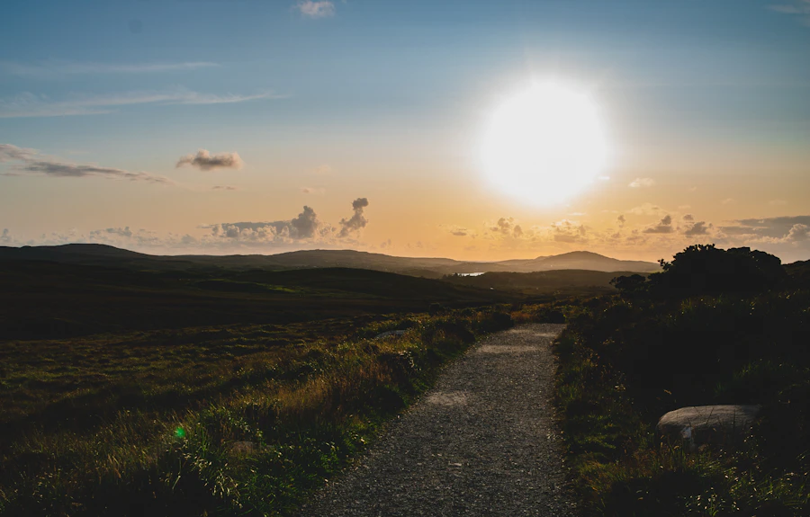 The sun rising over rolling Irish hills