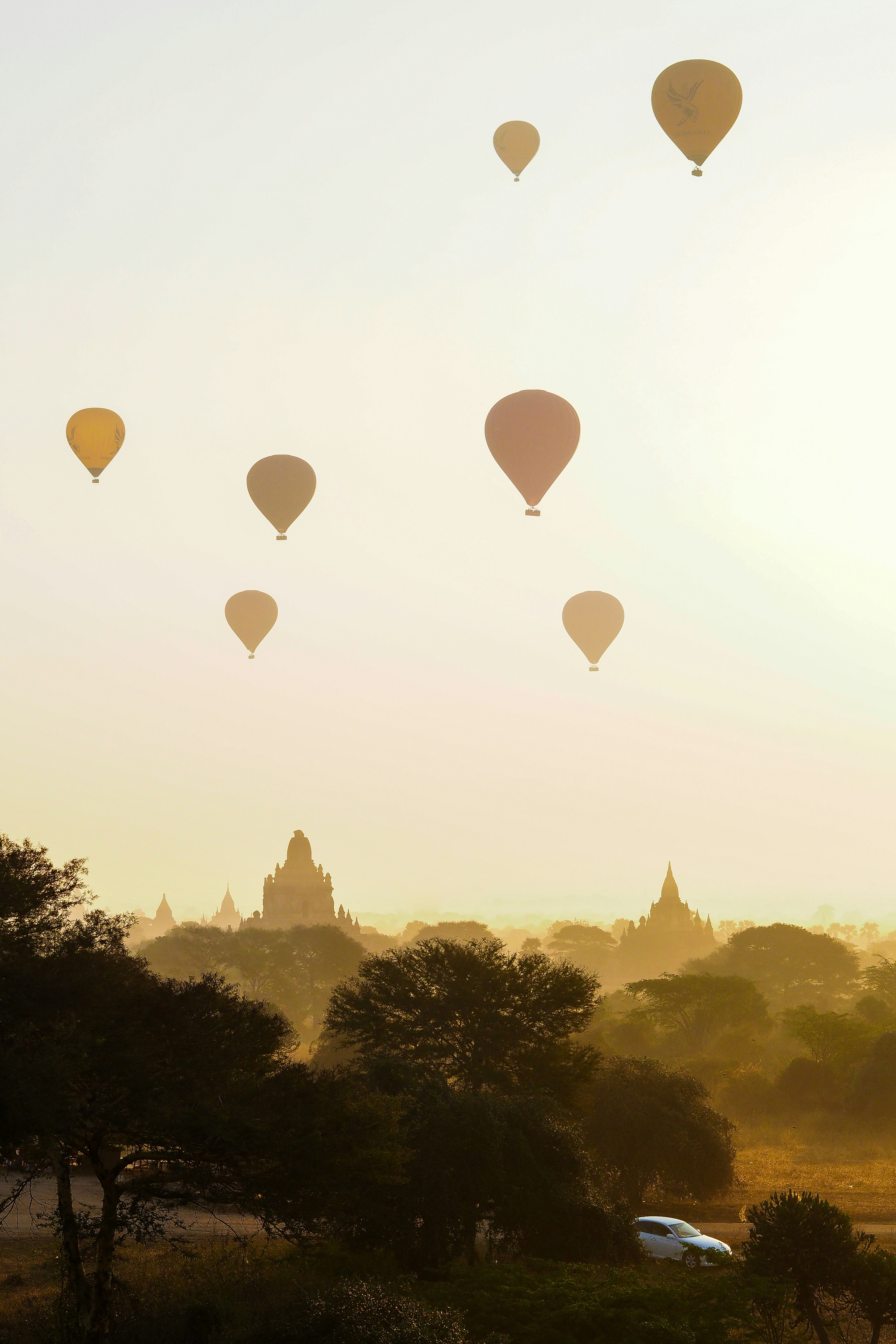 Sunrise in Bagan with balloons in sky.