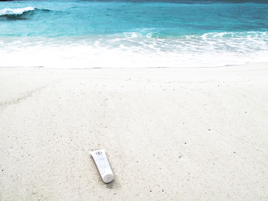 Sun protection lotions lined up with a sunny beach background.