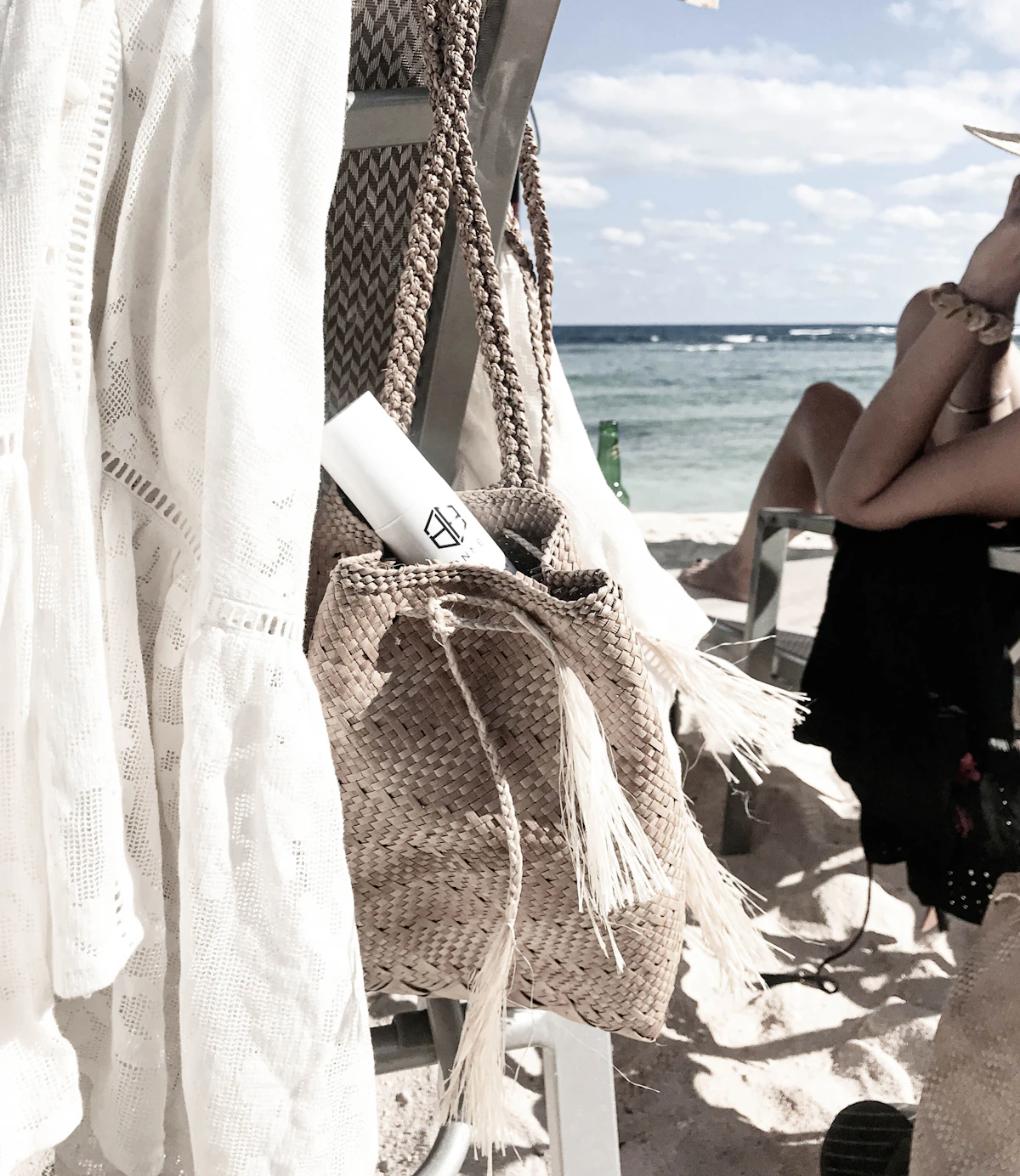 Woven straw bag hanging beside a beach chair