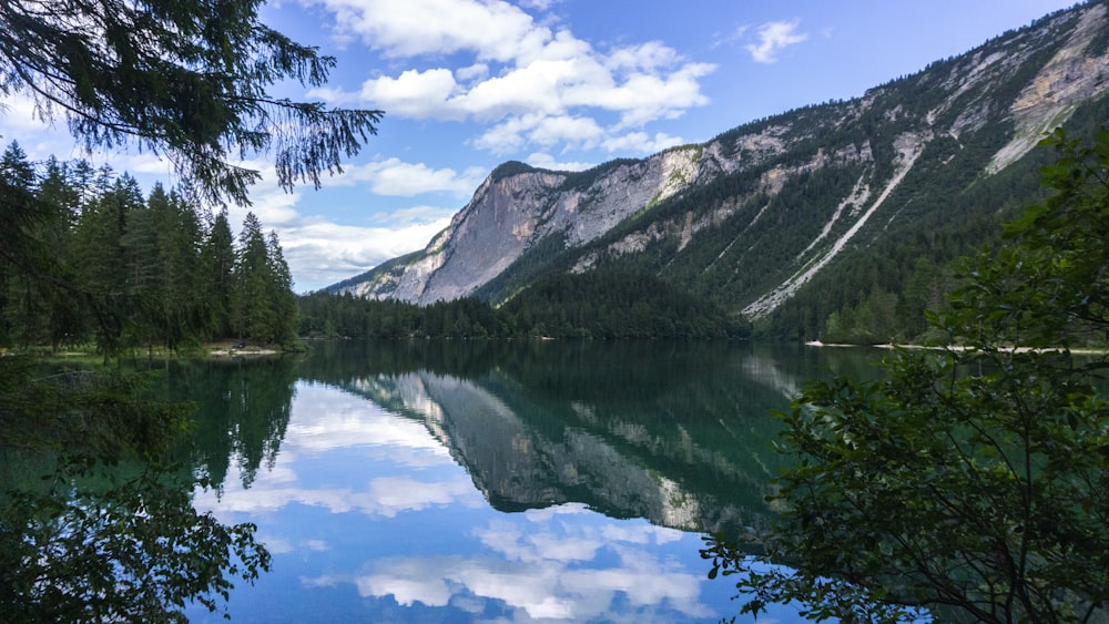 lake near mountain under blue sky