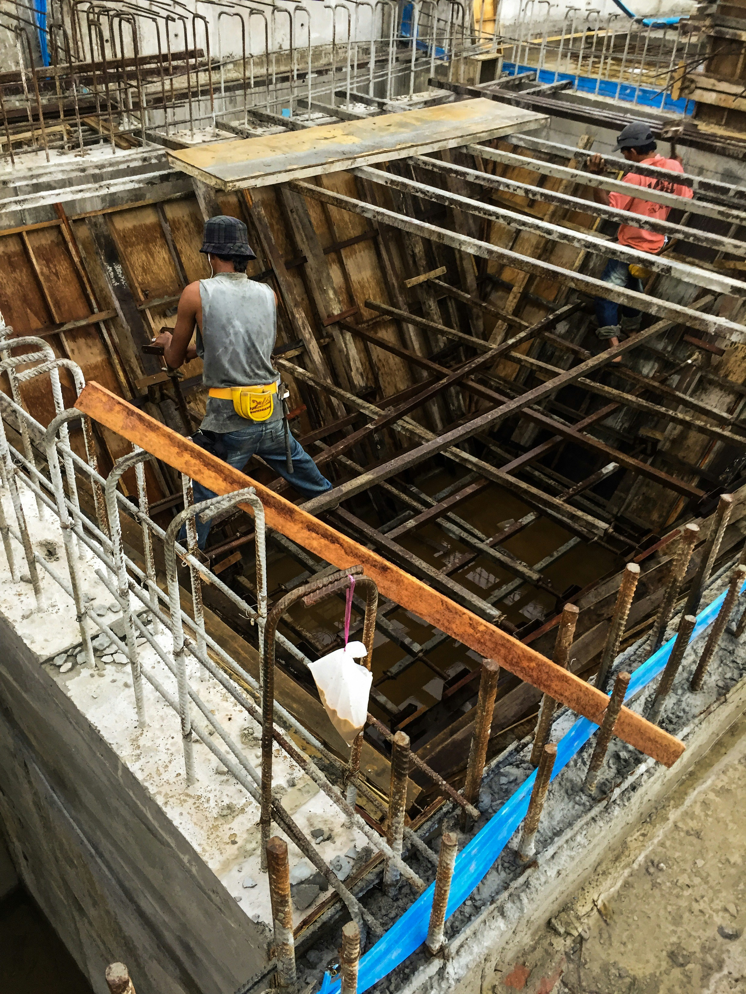 Building structural reinforcement work, steel rebar and concrete columns, professional construction crew