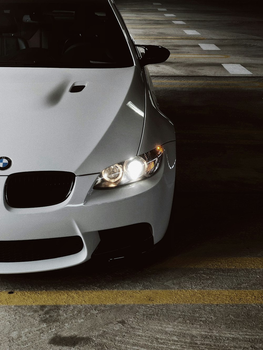 white BMW car showing headlight