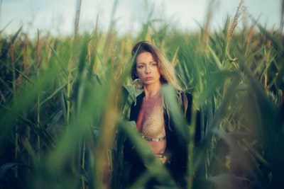 woman standing on corn field at daytime tasteful teams background