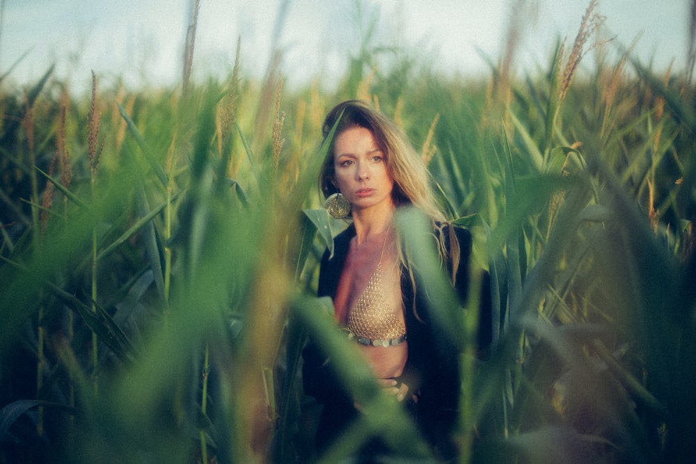 woman standing on corn field at daytime