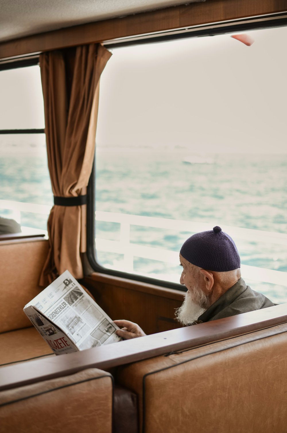 sitting man while reading newspaper