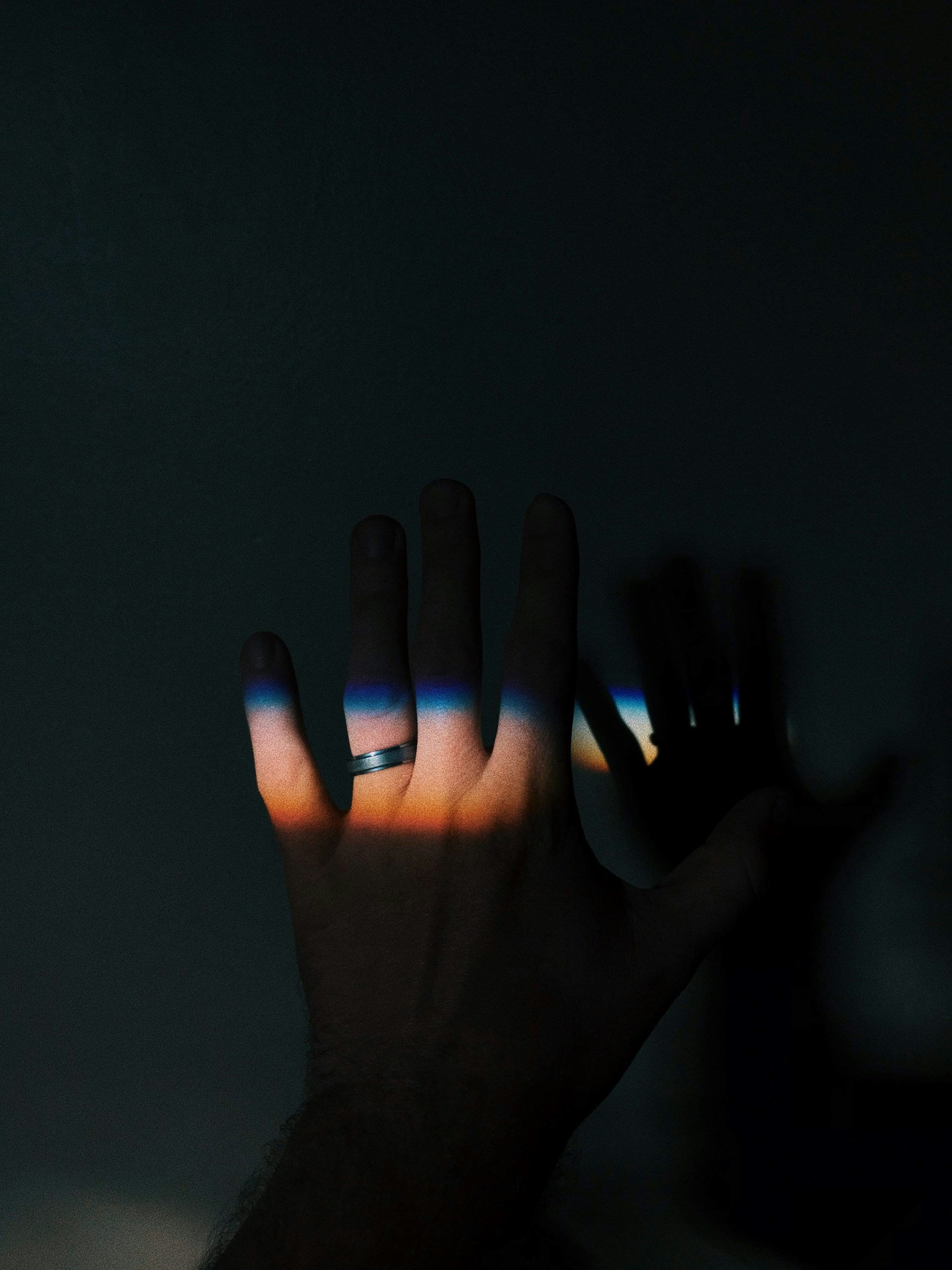 two persons showing silver-colored rings on light