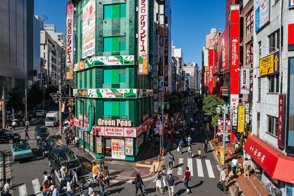 people walking in street beside building during daytime