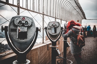 woman standing near the telescope