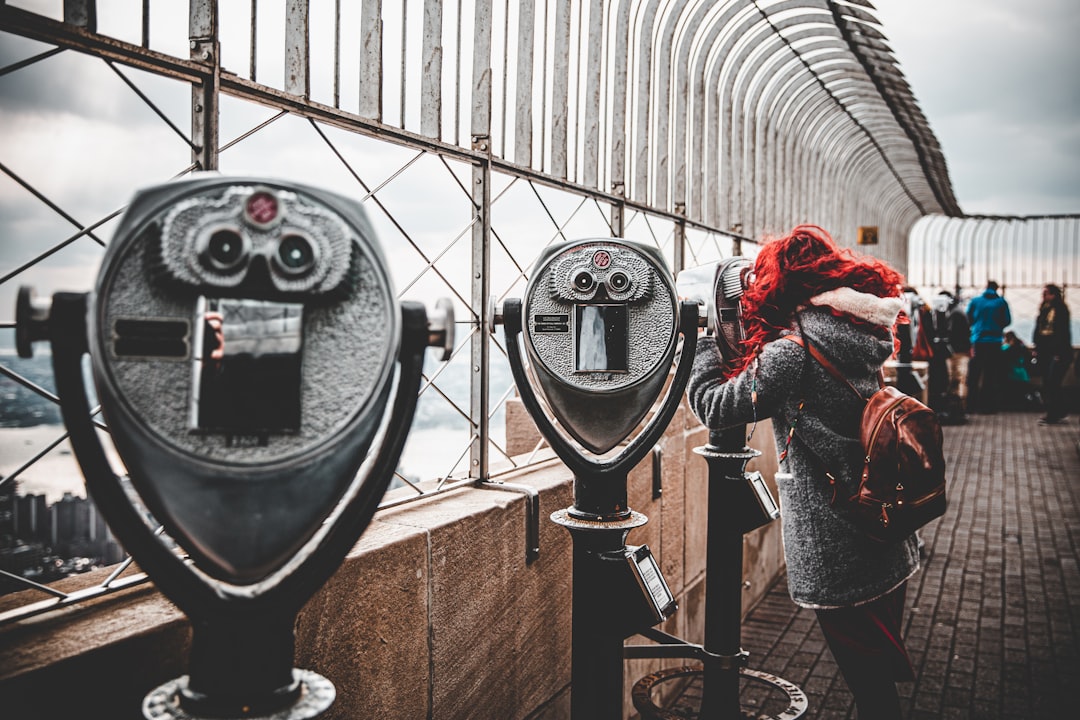 woman standing near the telescope