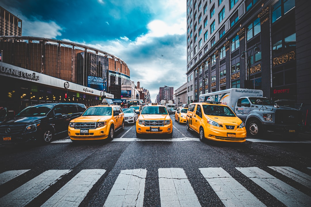 yellow vehicles on road during daytime