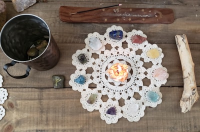 A neatly arranged flat lay of colorful spell kits with mystical symbols on Whidbey Island driftwood.