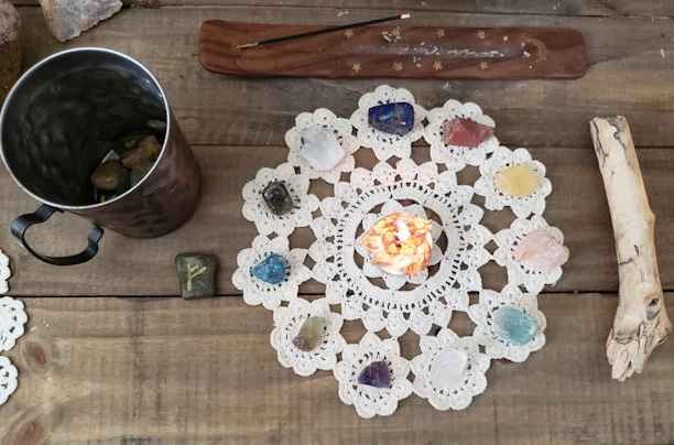 A cozy flat lay of herbal supplements, crystals, and favorite products on a wooden table.