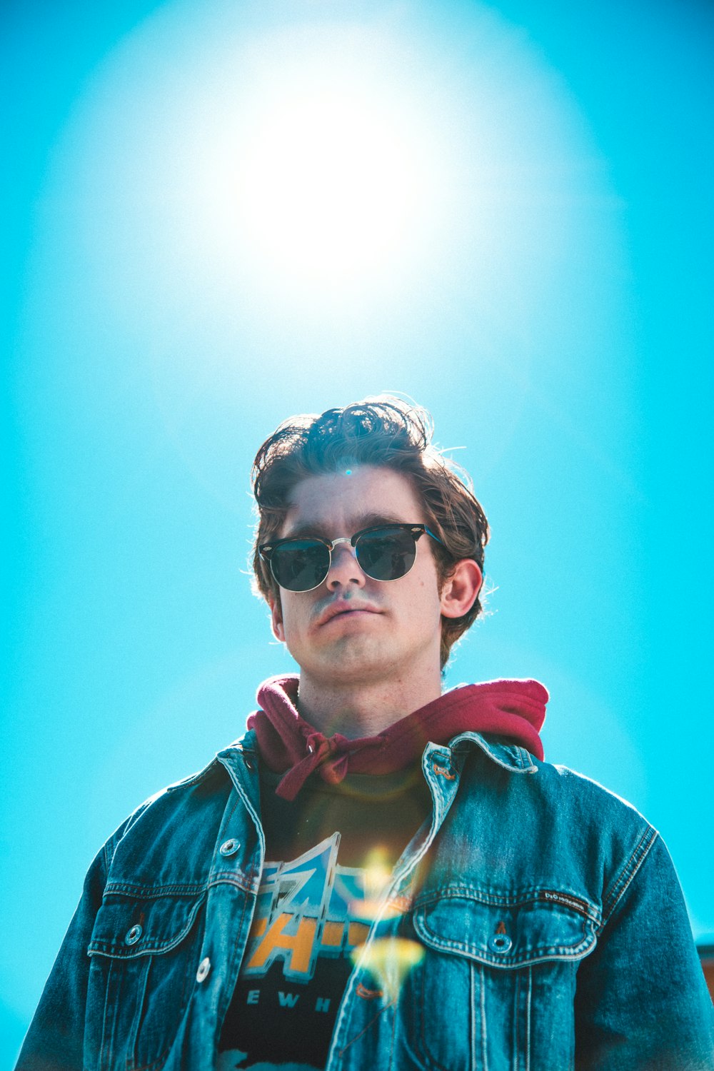 man wearing blue denim jacket