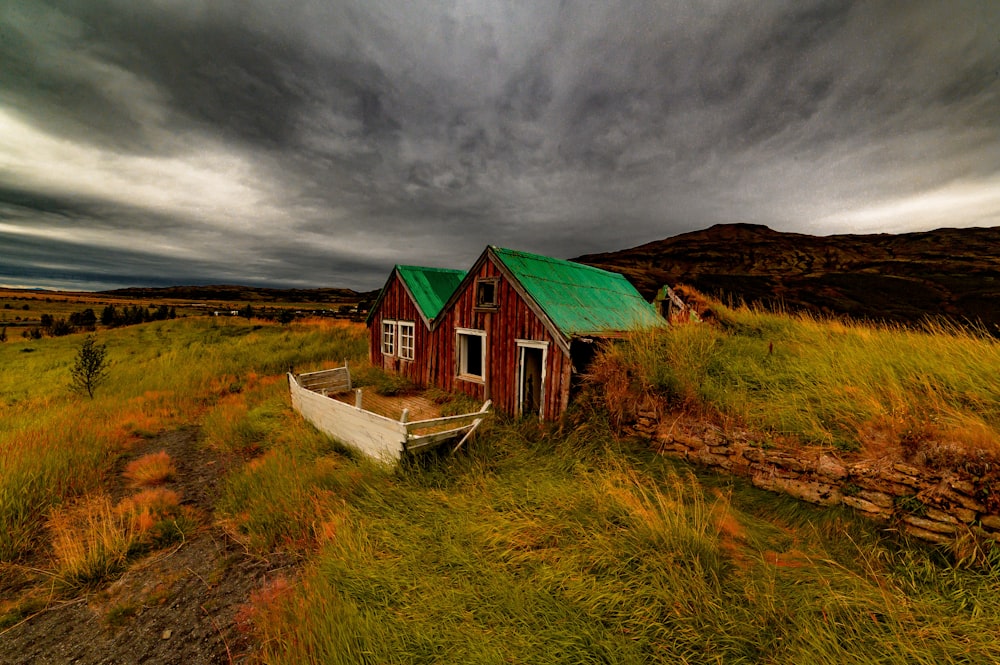 brown and green house surrounded by grass